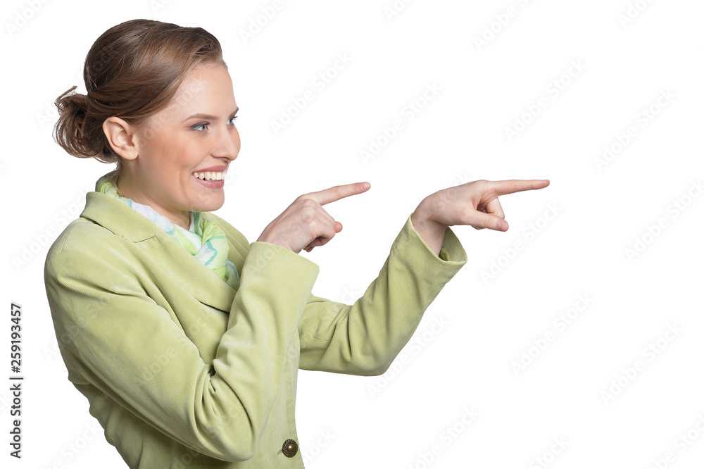 Portrait of smiling young woman pointing on white background Portrait of smiling young woman pointing on white background