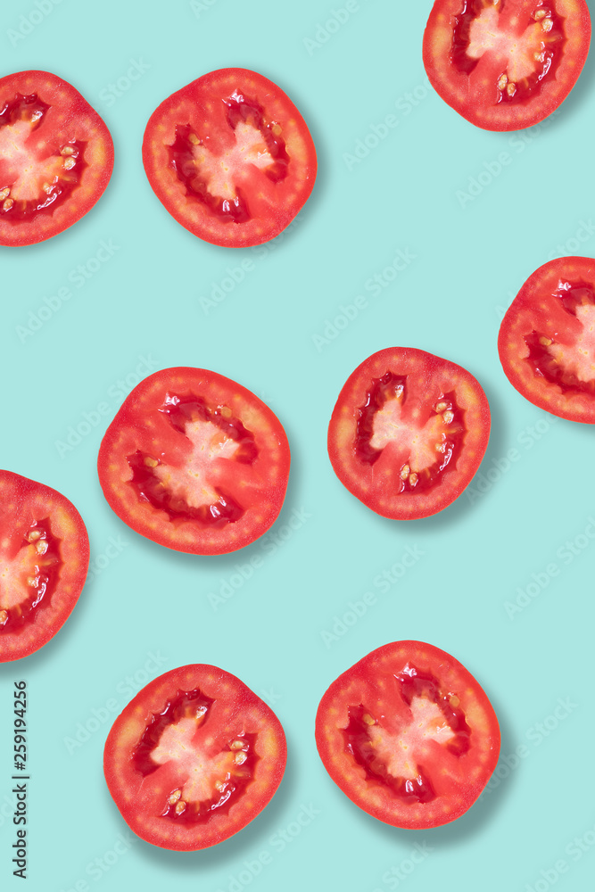 Fresh red tomatoes lay on a blue background. Fresh red tomatoes lay on a blue background.