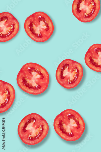 Fresh red tomatoes lay on a blue background.
