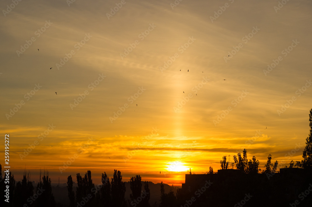 Fototapeta premium Landscape with dramatic light - beautiful golden sunset with saturated sky and clouds.