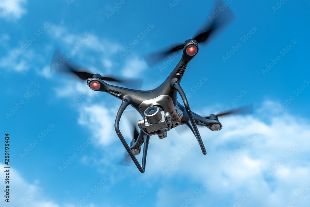 Modern beautiful dark drone in the sky.