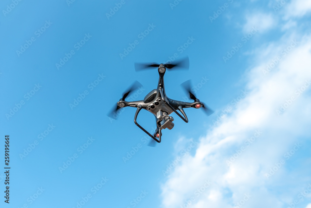 Modern beautiful dark drone in the sky. Modern beautiful dark drone in the sky.