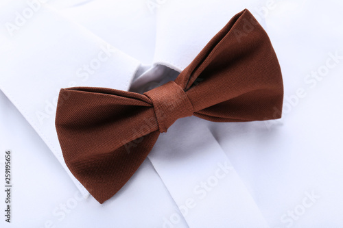 White shirt with brown bow tie