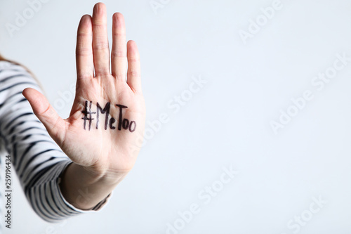 Woman showing palm with text Me Too on grey background