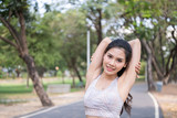 Concept of exercise. Beautiful girl stretching the muscles before running. Women exercising in the garden with freshness.