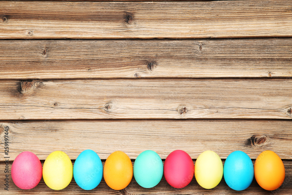 Colorful easter eggs on brown wooden table Colorful easter eggs on brown wooden table