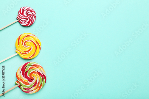 Colorful lollipops on mint background