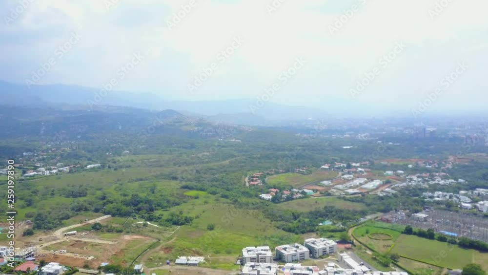 AERIAL: decently paced push, with a decent, through the terrain found in Cali, Colombia. AERIAL: decently paced push, with a decent, through the terrain found in Cali, Colombia.