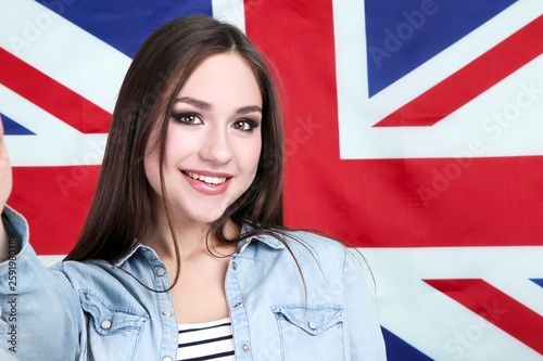 Young beautiful girl on British flag background