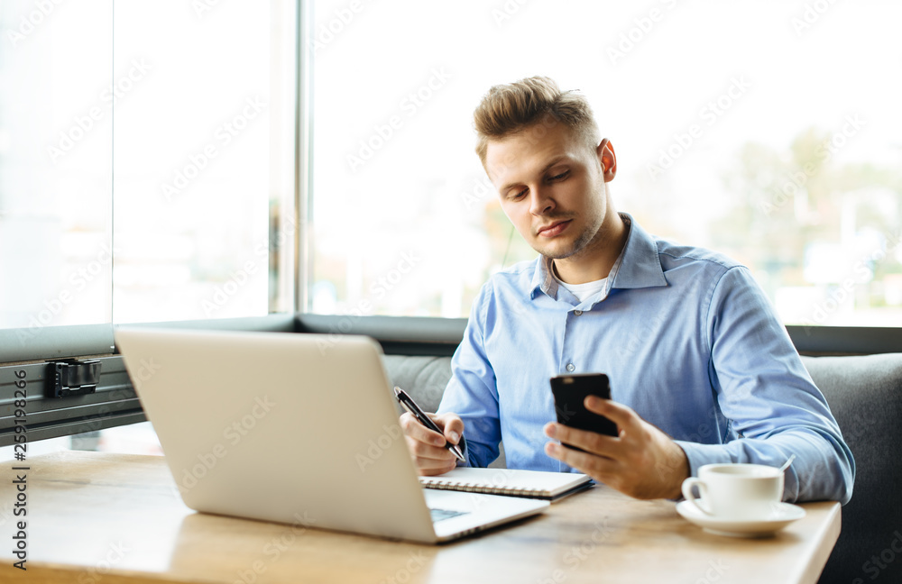 Stylish young man calling by the phone to solve business problems. Online consultation by phone. Freelancer discussing the development and planning of his online project. Outsourcing. Mobile services. Stylish young man calling by the phone to solve business problems. Online consultation by phone. Freelancer discussing the development and planning of his online project. Outsourcing. Mobile services.