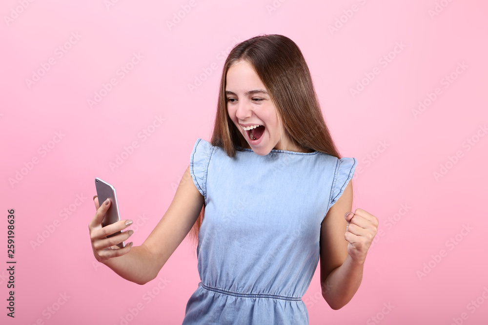 Screaming girl with smartphone on pink background Screaming girl with smartphone on pink background