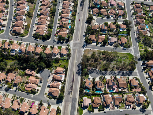 Aerial view suburban neighborhood with identical wealthy villas next to each other. San Diego, California, USA. Aerial view of residential modern subdivision luxury house with swimming pool.