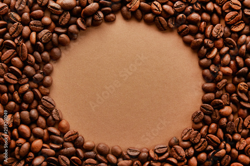 Scattered coffee beans frame design on copy space background.