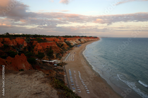 View of a coastline of the Portuguese Algarve, beach and mountains in the light of the sunset