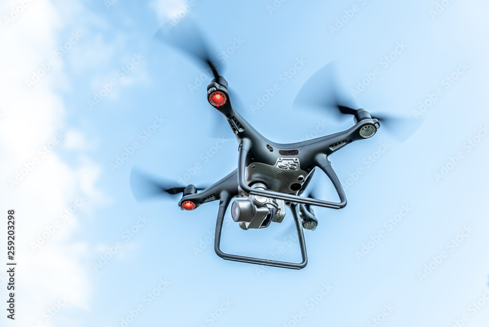 Modern beautiful dark drone in the sky. Modern beautiful dark drone in the sky.
