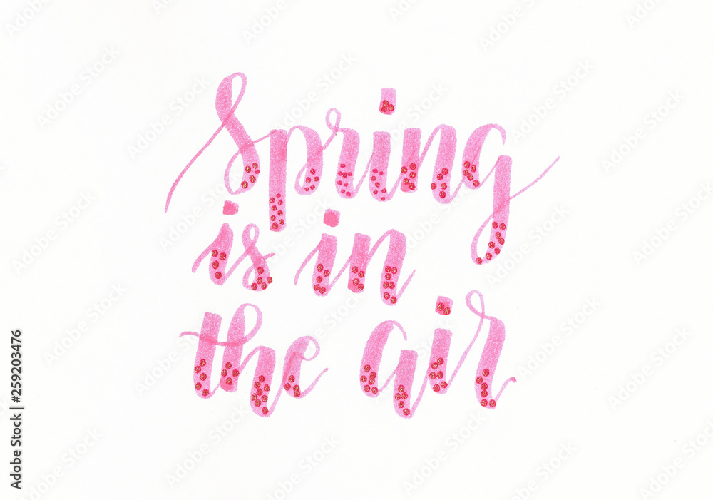 Spring is in the air - hand lettering inscription in pink with dots Spring is in the air - hand lettering inscription in pink with dots