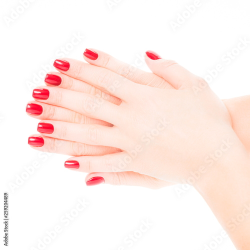 Hands of a young woman with red manicure on nails