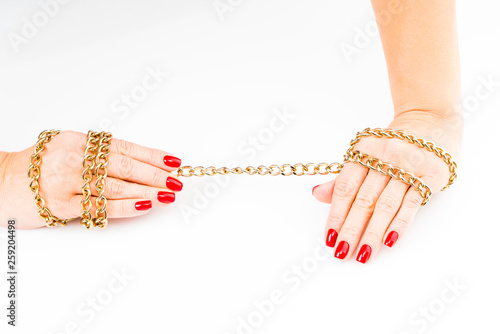 close up photo hands with red manicure holding chain on white