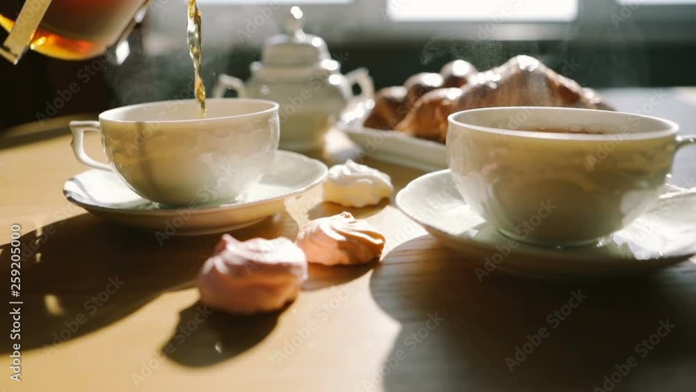 ideal morning moment. tea is poured into cups from french press. Croissants and sweets. Sweet breakfast breakfast. Video footage ideal morning moment. tea is poured into cups from french press. Croissants and sweets. Sweet breakfast breakfast. Video footage