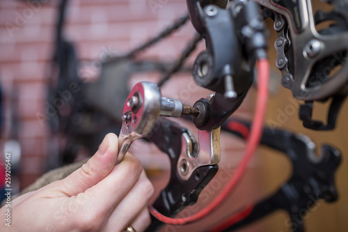 Bicycle mechanic in a workshop in the repair process 