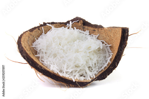 fresh coconut flakes placed in bark and shell isolated on white background