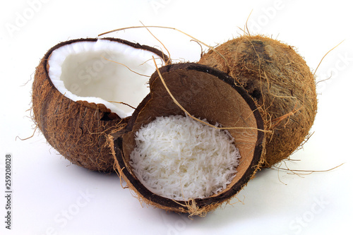 fresh coconut flakes placed in bark and shell isolated on white background