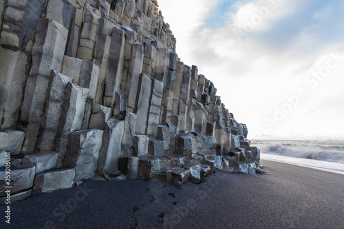 Black sand beach in Iceland with vocanic rock photo