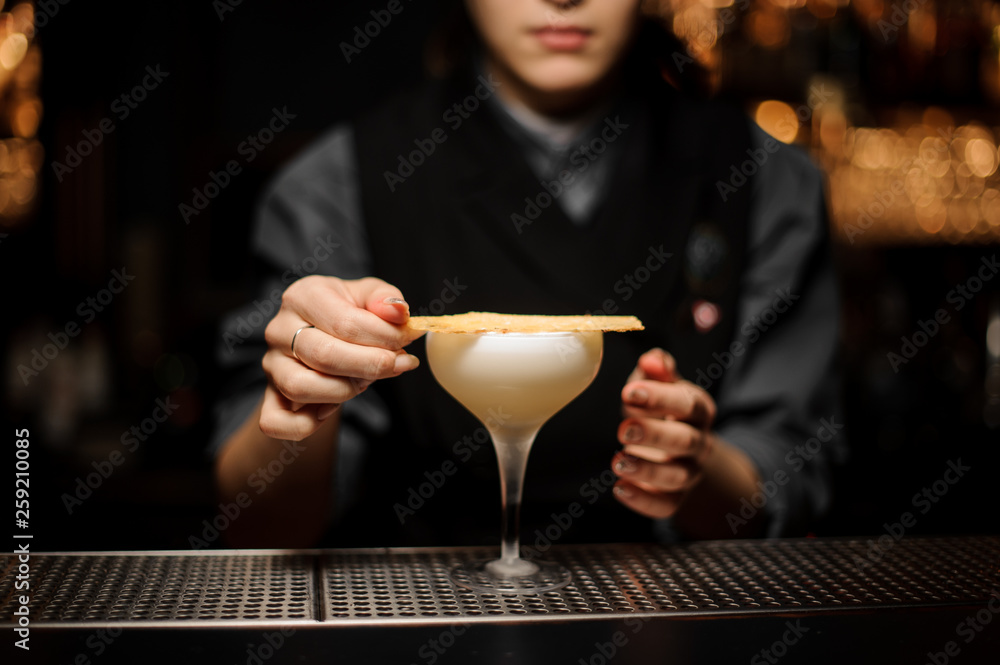 Bartender pours an alcohol cocktail in glass Bartender pours an alcohol cocktail in glass