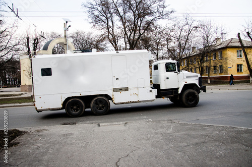 Obraz na plátně Armored truck, collectors, mail. White protected car in the city