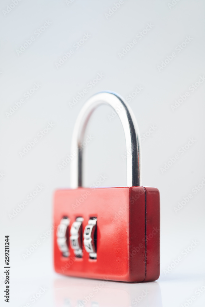 Close up photo of red closed code padlock isolated on white or gray background Close up photo of red closed code padlock isolated on white or gray background