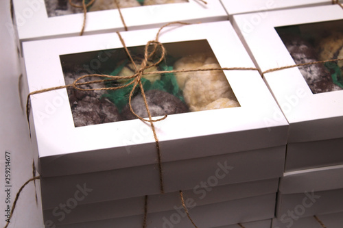 packed and rope tied cookie boxes with transparent cover and and a label for text