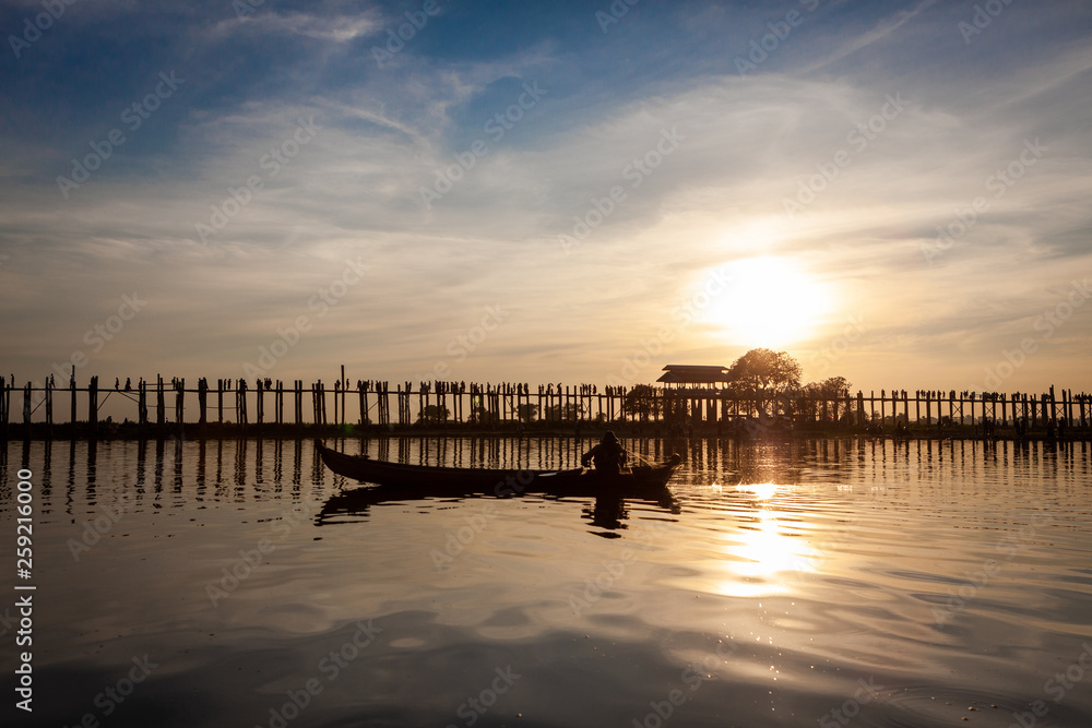 Sunset over U Bein Wooden bridge with locals' and tourists' silhouettes, Mandalay, Myanmar (Burma). Sunset over U Bein Wooden bridge with locals' and tourists' silhouettes, Mandalay, Myanmar (Burma).