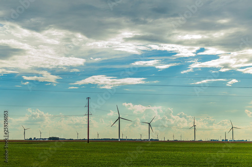 wind turbines in green field blue sky