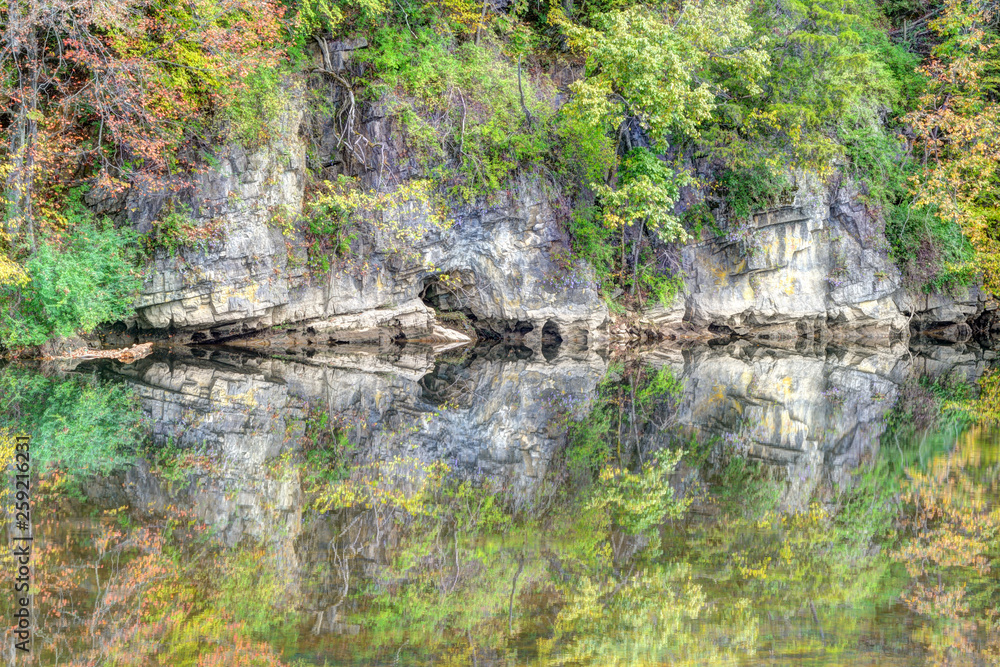Abstract - Water reflections of trees hanging over a cliff.