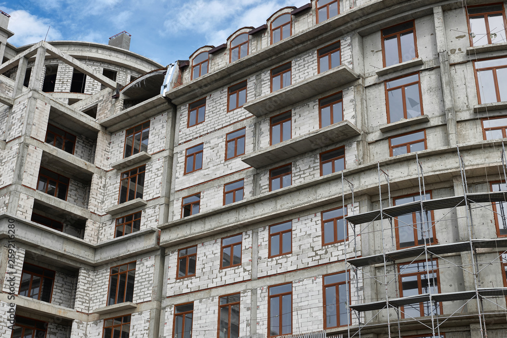 Fototapeta premium new building under construction, scaffolding and concrete