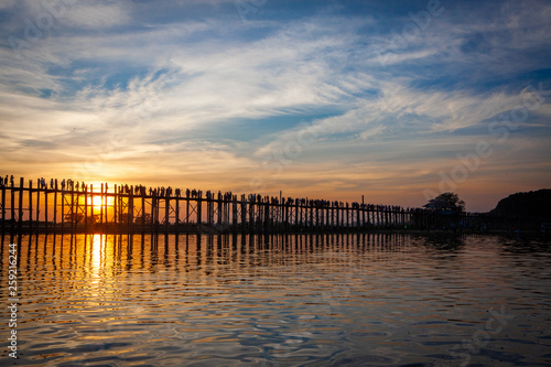 Sunset over U Bein Wooden bridge with locals  and tourists  silhouettes  Mandalay  Myanmar