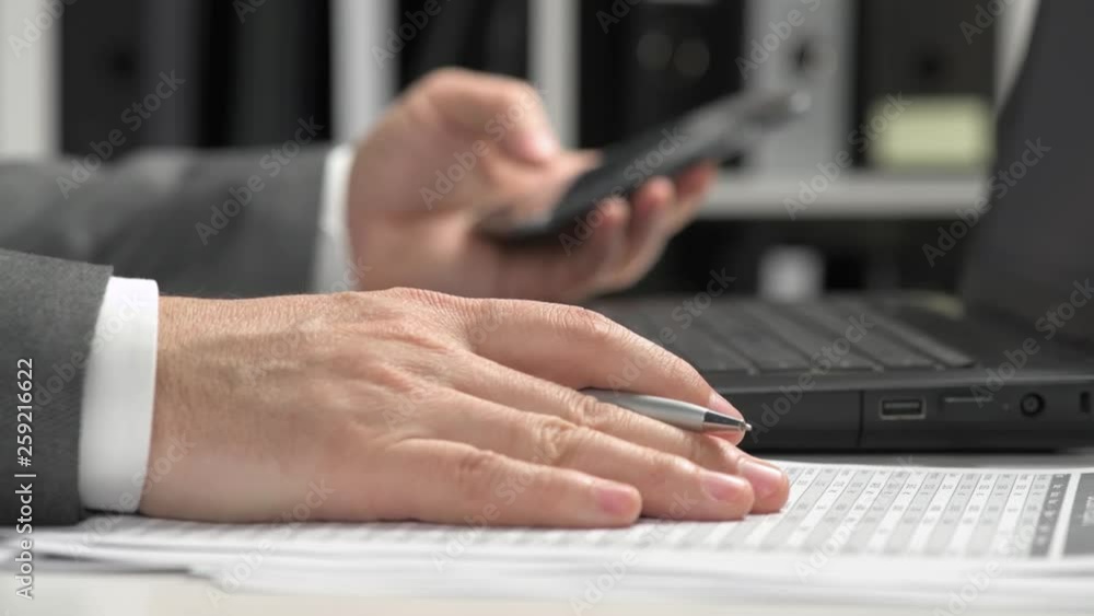 Businessman working in an office and using smartphone and laptop. Business financial accounting concept. Businessman working in an office and using smartphone and laptop. Business financial accounting concept.