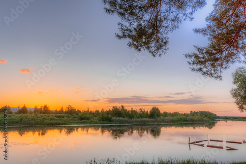 Blue sunset sky over the river in summer