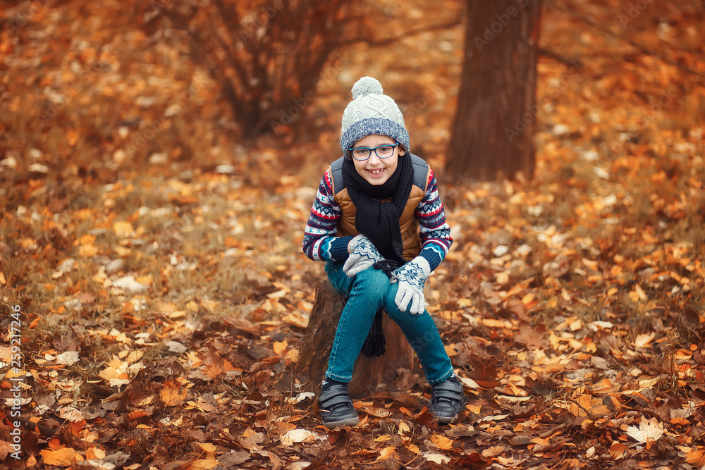 A child with glasses in the background of an autumn landscape A child with glasses in the background of an autumn landscape