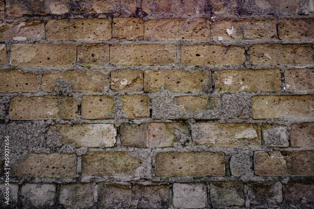 old brick wall and missing bricks in ruins.