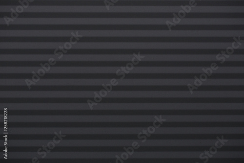 Black clear background with corrugated iron in horizontal orientation.