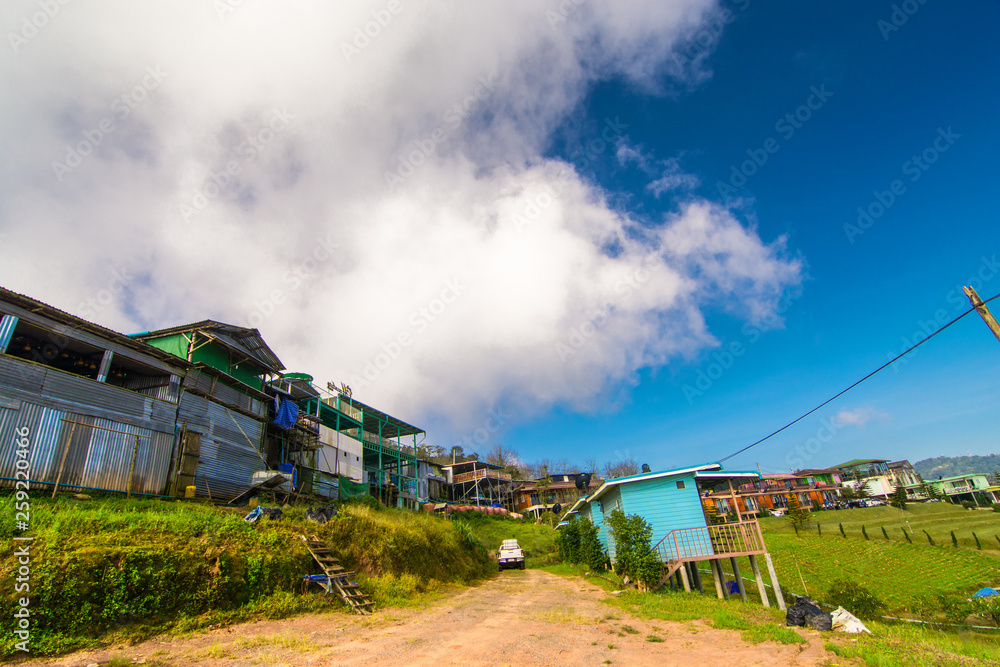 A small village in the middle of the mountains and a wide sky, low clouds, rural life in Thailand