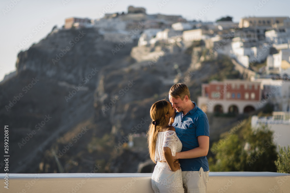 young couple honeymoon on the most romantic island Santorini, Greece, view of Santorini