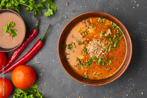 Traditional Georgian soup Kharcho with meat and rice on dark stone background photo