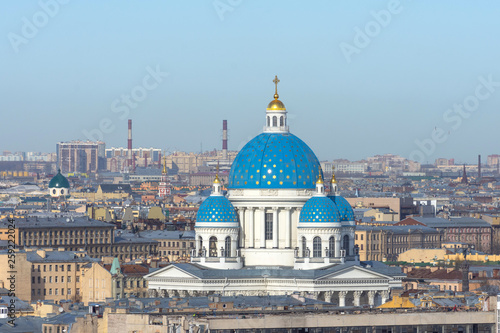 Trinity Cathedral with a blue dome and gold stars on the background of roofs in the city of St. Petersburg. © aapsky