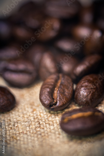 Fototapeta Naklejka Na Ścianę i Meble -  Coffee beans, close-up on rough sackcloth 