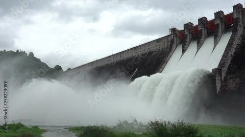 Slow motion of water dam drained from outlet pipe of the dam where is the hydropower electrical generation