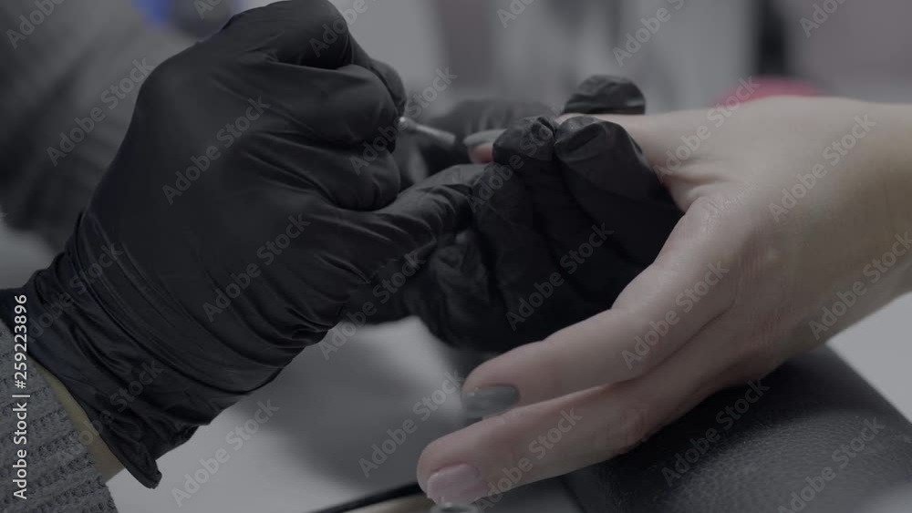 Closeup manicurist in black latex gloves makes a manicure on the model's hand in the beauty salon. Ultra HD. 4K, 3840x2160. 25 FPS Closeup manicurist in black latex gloves makes a manicure on the model's hand in the beauty salon. Ultra HD. 4K, 3840x2160. 25 FPS