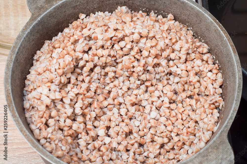 Buckwheat as a source of essential amino acids and ideal products for athletes in a cauldron on the table kihni cooked and ready for use. Buckwheat as a source of essential amino acids and ideal products for athletes in a cauldron on the table kihni cooked and ready for use.