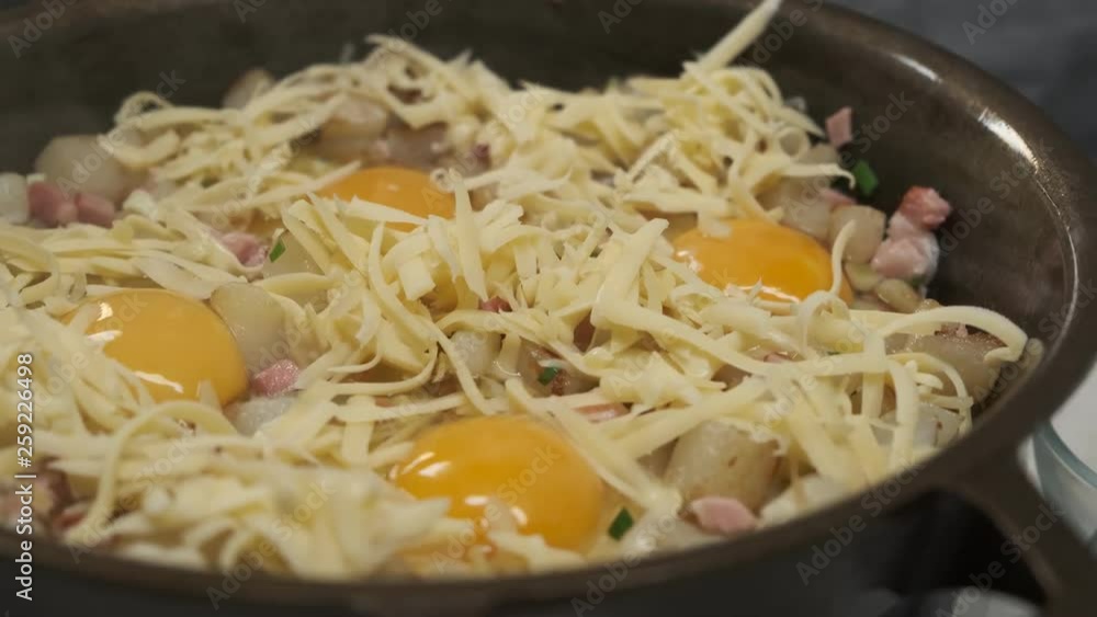 Homemade cooking eggs with cheese and herbs on pan for breakfast, close up food video. Homemade cooking eggs with cheese and herbs on pan for breakfast, close up food video.